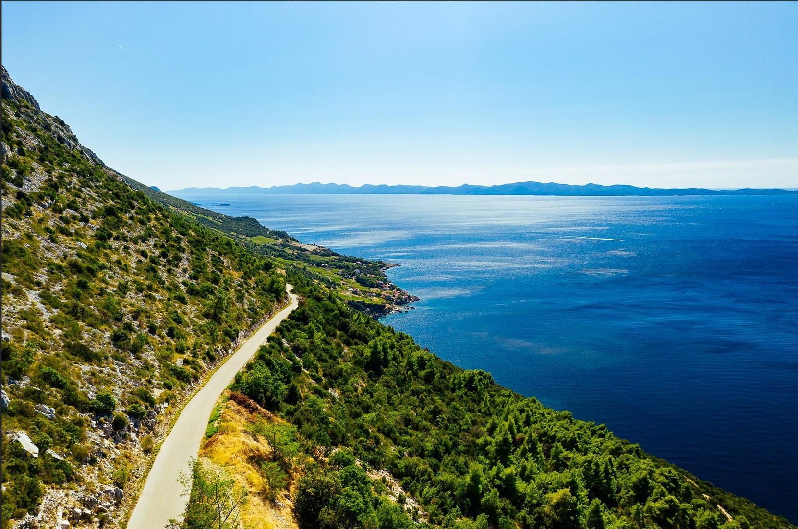 cycling path in croatia seen with a drone - near a cliff